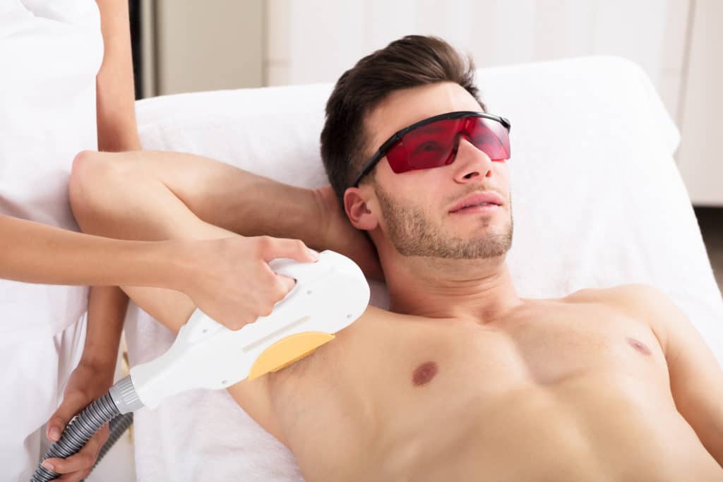 Young man Having Underarm Laser Hair Removal Treatment